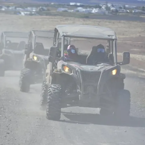 Buggies driving in convoy along a dusty track