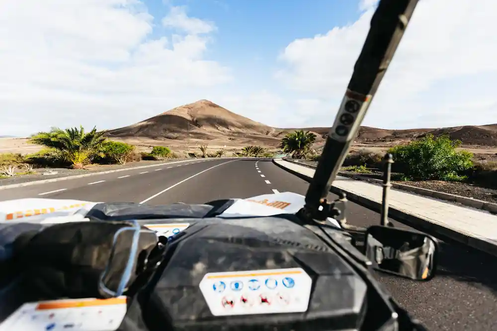 Buggy dashboard view driving on volcanic island road