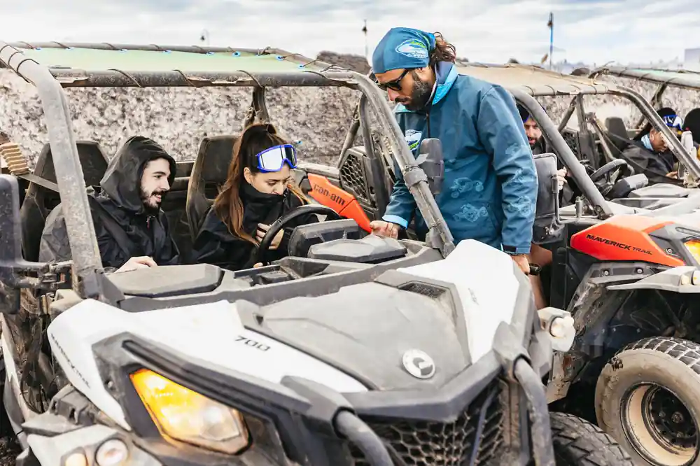 Guide instructing buggy drivers in desert setting