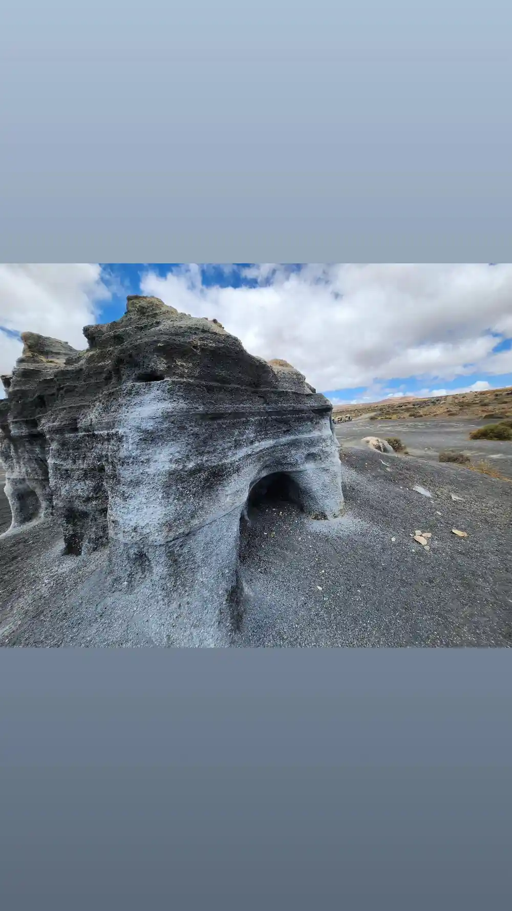 Large eroded white rock formation on barren plateau