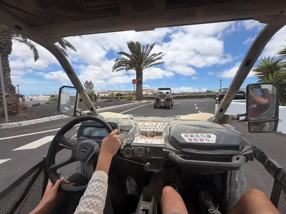 Parked buggy vehicle on volcanic landscape with hill